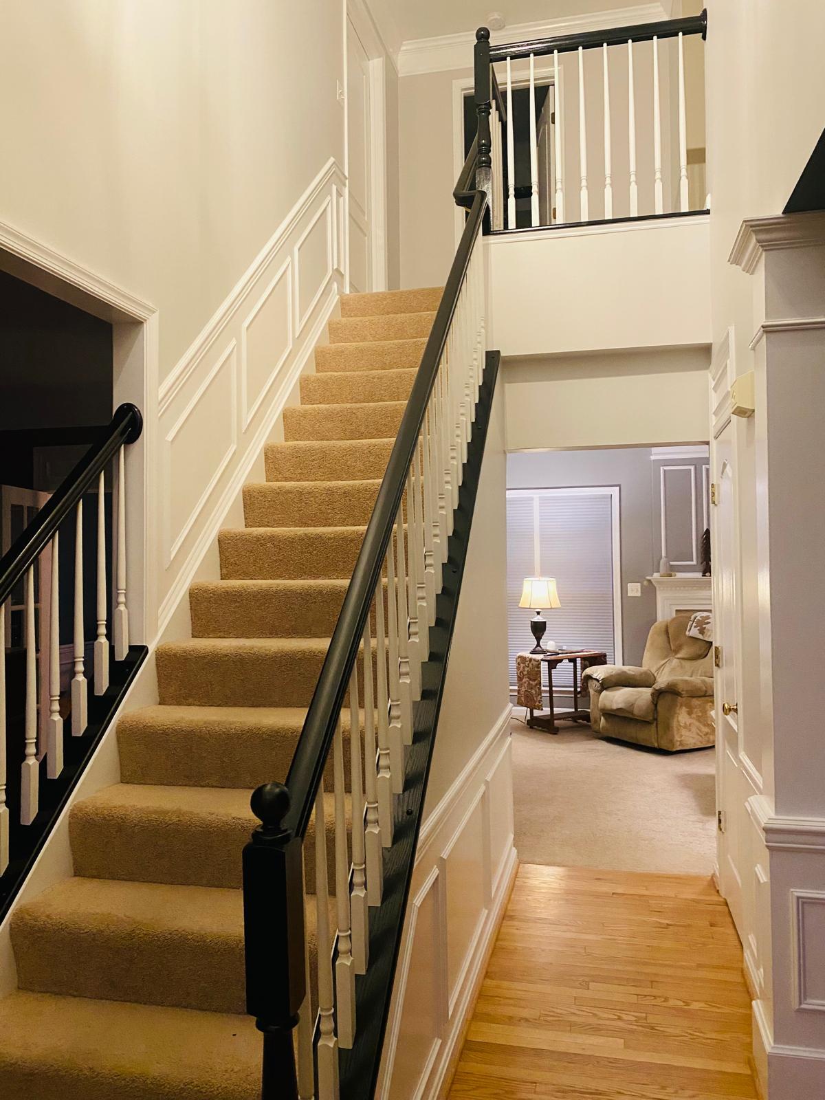 Finished staircase with dark wood railing